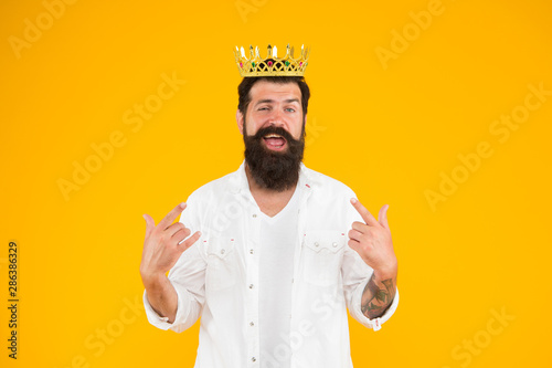 Superiority complex. Narcissistic person. Love yourself. Sense of self importance. Responsibility being king. Handsome bearded guy king. King crown. Egoist selfish man. Bearded man in white clothes