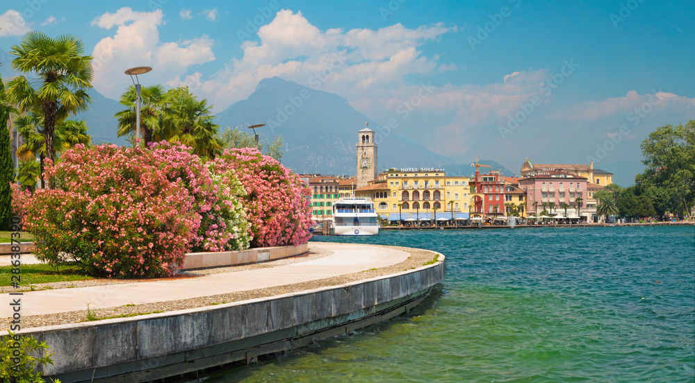 RIVA DEL GARDA, ITALY - JUNE 6, 2019: The City from south with the Alps in the backgound.