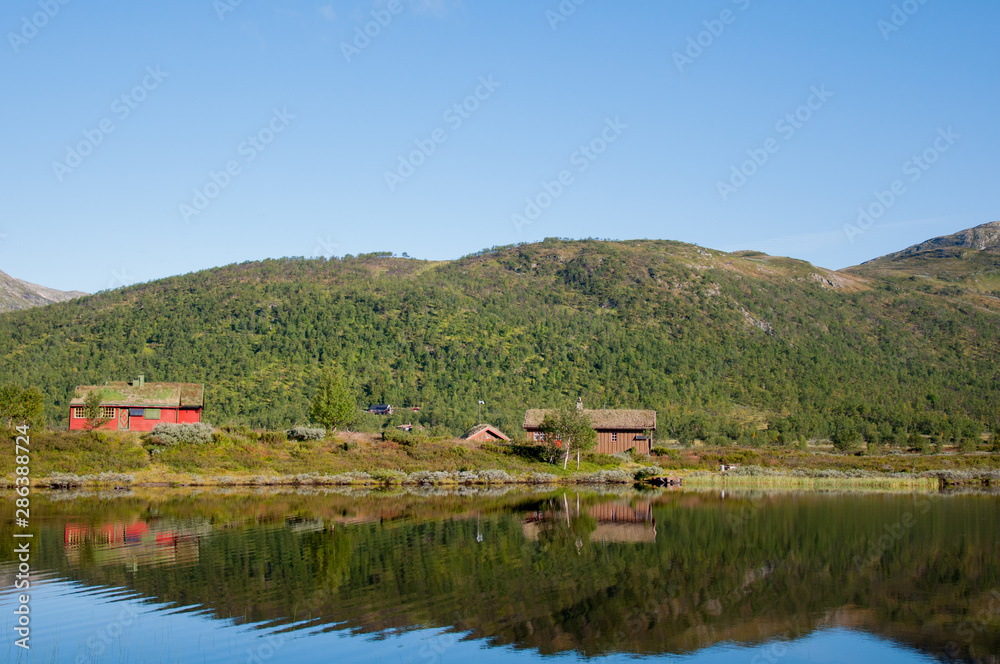 Amazing nature view with fjord and mountains. Beautiful reflection. Location: Scandinavian Mountains, Norway. Amazing nature view with fjord and mountains. Beautiful reflection. Location: Scandinavian Mountains, Norway.