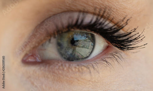 Female eye with long eyelashes close up.
