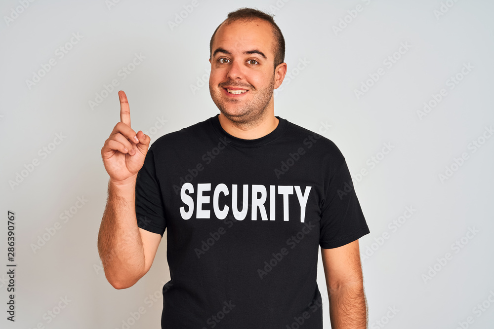 Young safeguard man wearing security uniform standing over isolated white background surprised with an idea or question pointing finger with happy face, number one Young safeguard man wearing security uniform standing over isolated white background surprised with an idea or question pointing finger with happy face, number one