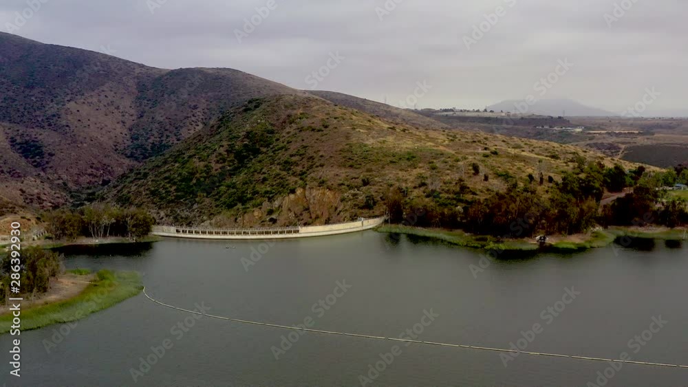Drone fly over Dam at Otay Lakes County Park. Aerial view late afternoon of artificial lake in Eastlake Chula Vista, San Diego County, California Drone fly over Dam at Otay Lakes County Park. Aerial view late afternoon of artificial lake in Eastlake Chula Vista, San Diego County, California
