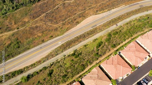 Eastlake, Chula Vista ,San Diego, CA. Aerial Tilt  Reveal Otay Lakes reservoir. Drone view of american wealth district to mountain and lake landscape. Residential area with amazing scenery. photo