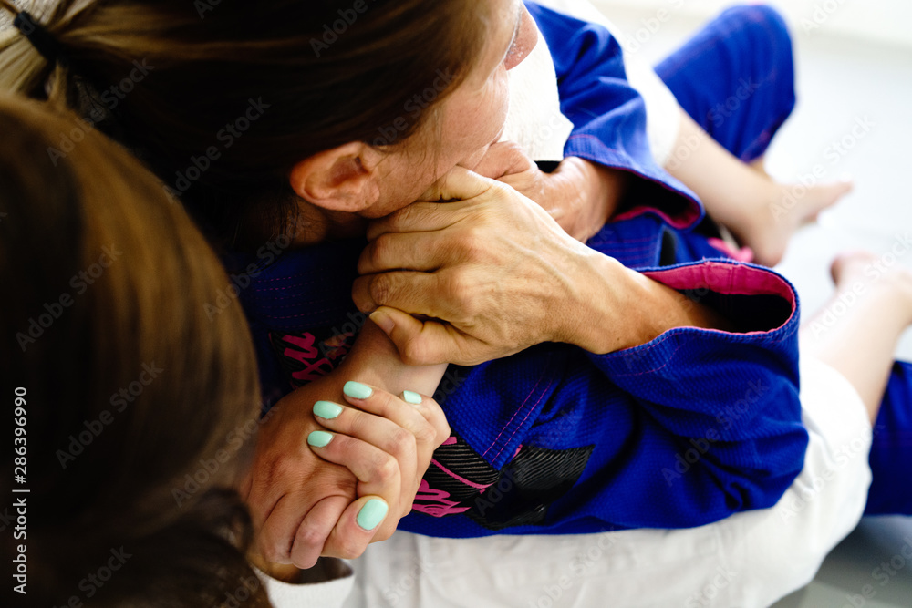 Rear naked choke RNC mata leao brazilian jiu jitsu judo martial arts  submission deadly technique for self defense two woman at training sparing  fight wearing kimono Stock Photo | Adobe Stock