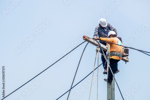lineman working on hydroelectric pole