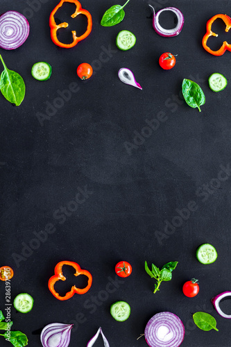Cook frame with fresh vegetables on black background top view space for text
