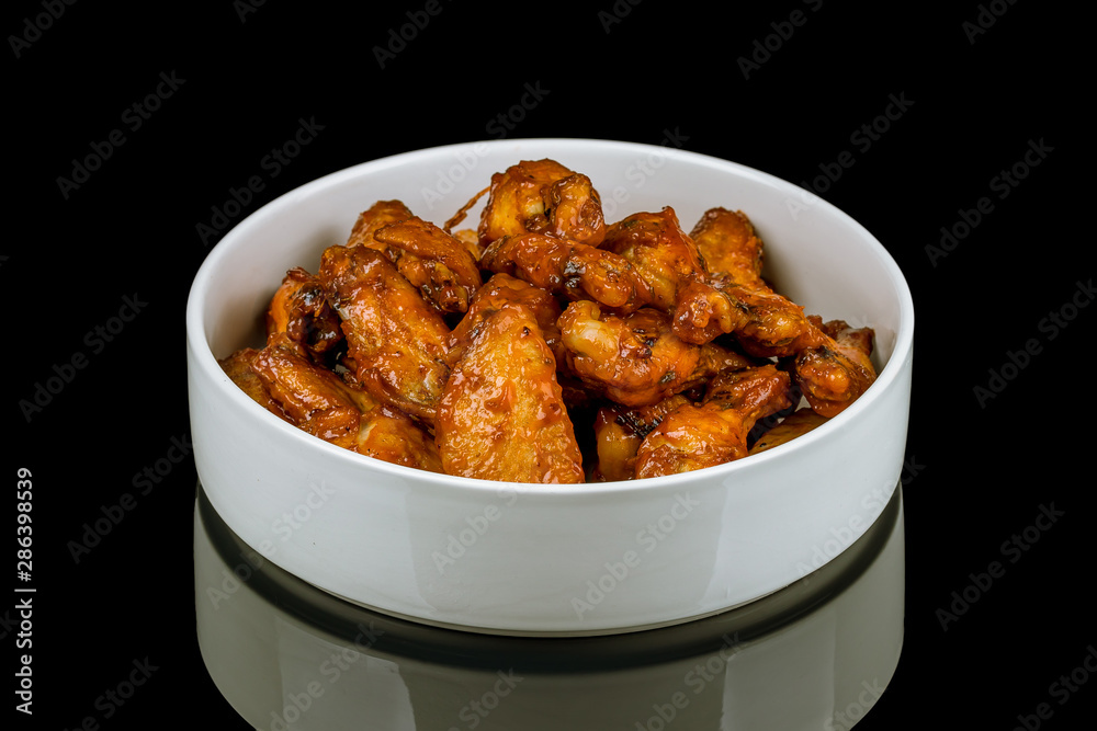 chicken wings in barbecue sauce on black with reflection chicken wings in barbecue sauce on black with reflection