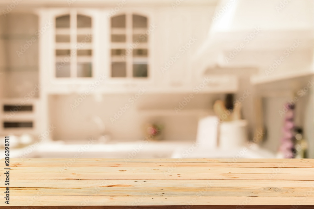 Empty wood table top on blurred Blurred background,Modern kitchen with bokeh light, vintage filter or display your products Empty wood table top on blurred Blurred background,Modern kitchen with bokeh light, vintage filter or display your products