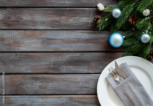 Table setting with spruce, plate, flatware on wooden background top view mock-up