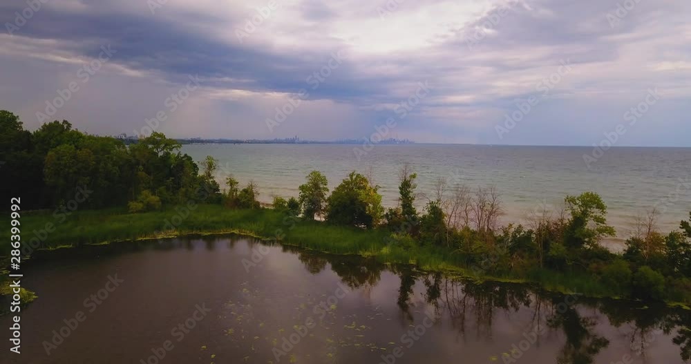 Aerial flyover of a marsh and lake shore on an overcast, rainy day Aerial flyover of a marsh and lake shore on an overcast, rainy day