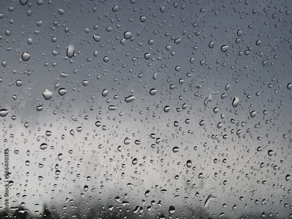 beautiful raindrops on the glass through which you can see the stormy gray sky beautiful raindrops on the glass through which you can see the stormy gray sky