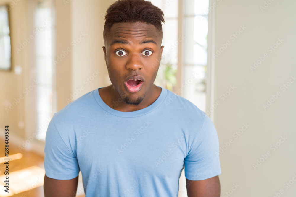 Handsome african american man wearing casual t-shirt afraid and shocked with surprise expression, fear and excited face. Handsome african american man wearing casual t-shirt afraid and shocked with surprise expression, fear and excited face.