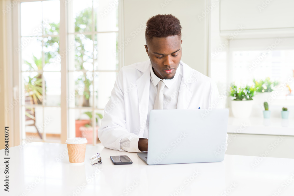 Handsome african proffesional man working using laptop for the business serious and concentrated