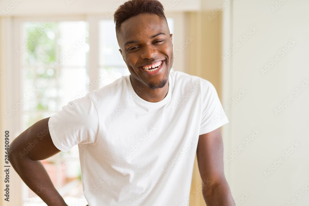 Handsome african young man smiling cheerful with a big smile on face Handsome african young man smiling cheerful with a big smile on face