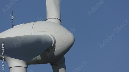 Close up spinning Wind turbine with summer sunny blue sky as background and copy space. photo