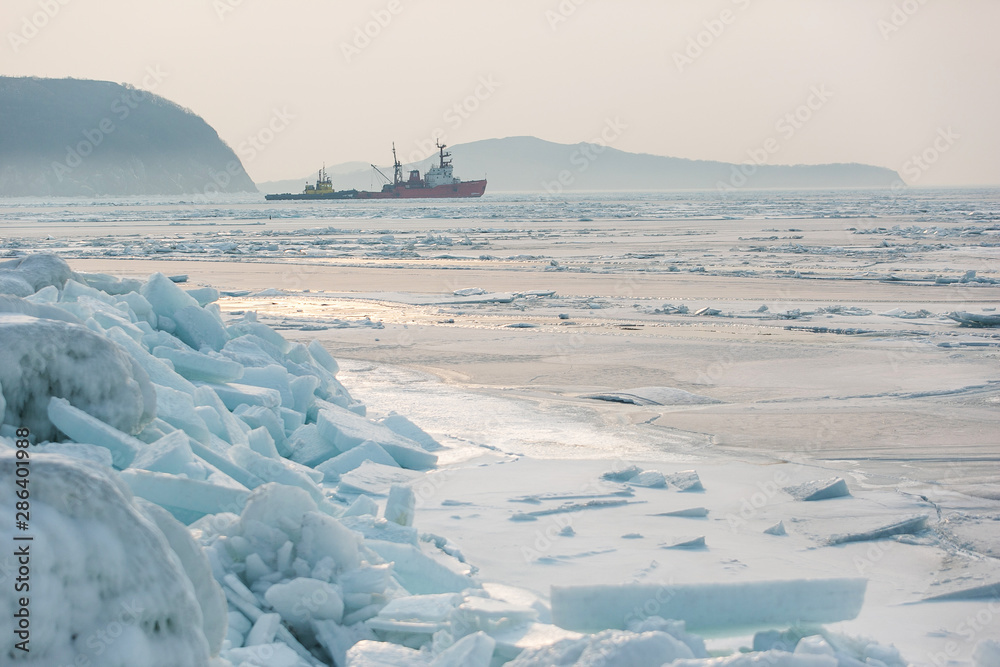 Two small ships stuck in arctic ice ice. Ships on a raid in the Arctic ice