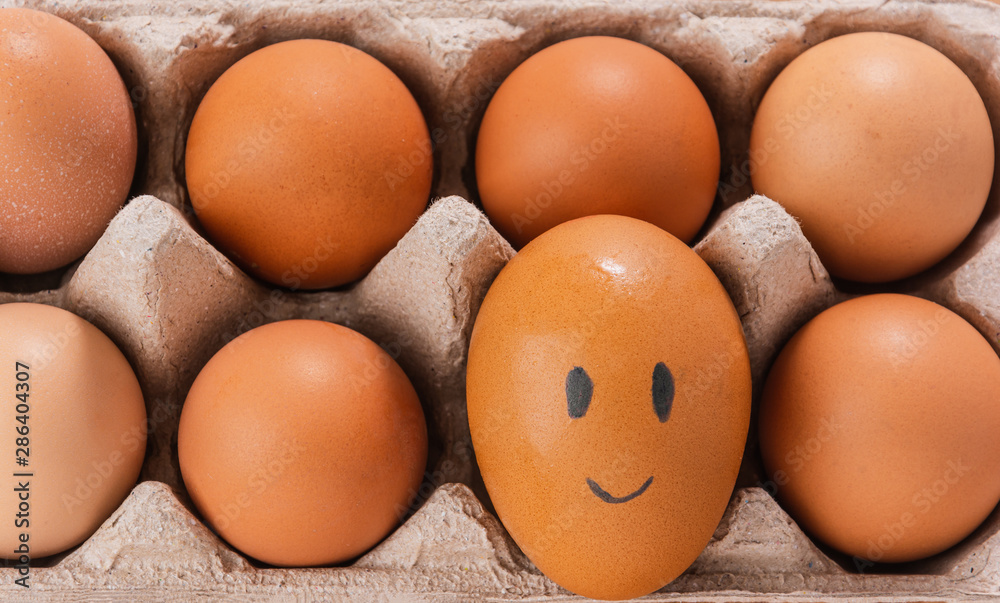 drawing smile face on chicken egg in tray drawing smile face on chicken egg in tray
