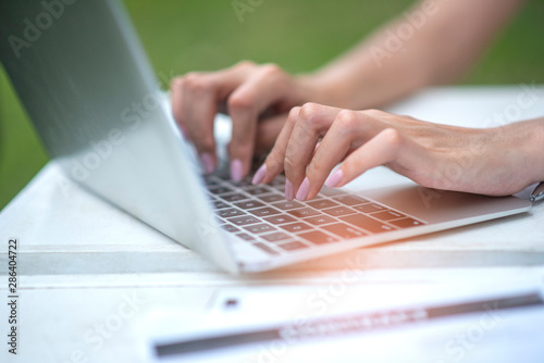 Closeup hand of a businesswoman is carrying a computer
