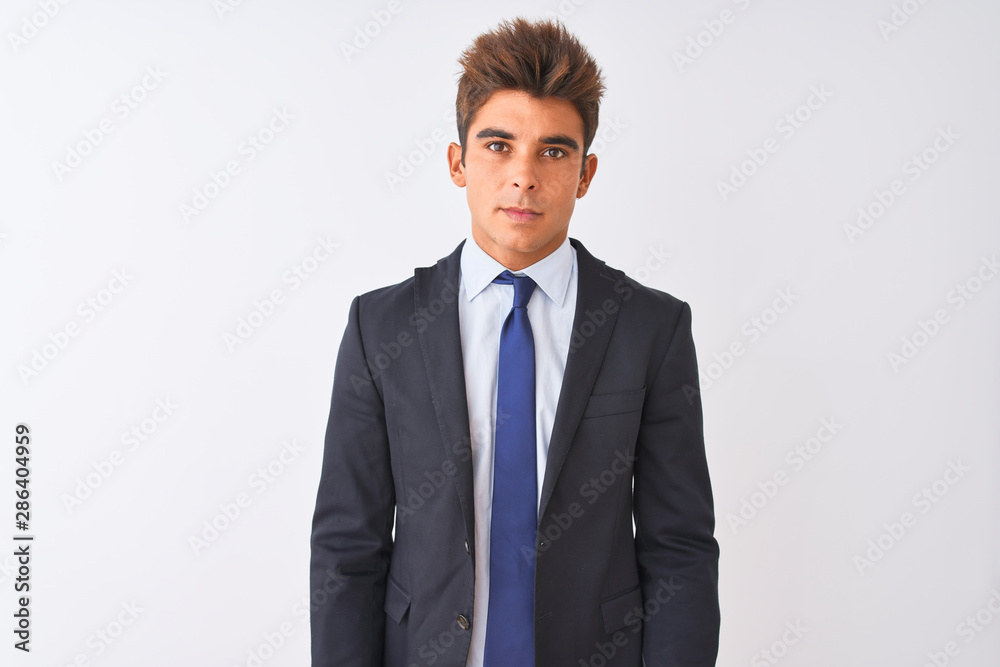 Young handsome businessman wearing suit standing over isolated white background Relaxed with serious expression on face. Simple and natural looking at the camera. Young handsome businessman wearing suit standing over isolated white background Relaxed with serious expression on face. Simple and natural looking at the camera.