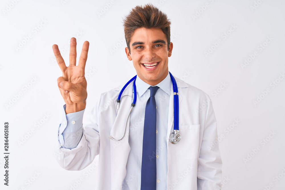 Young handsome doctor man wearing stethoscope over isolated white background showing and pointing up with fingers number three while smiling confident and happy. Young handsome doctor man wearing stethoscope over isolated white background showing and pointing up with fingers number three while smiling confident and happy.