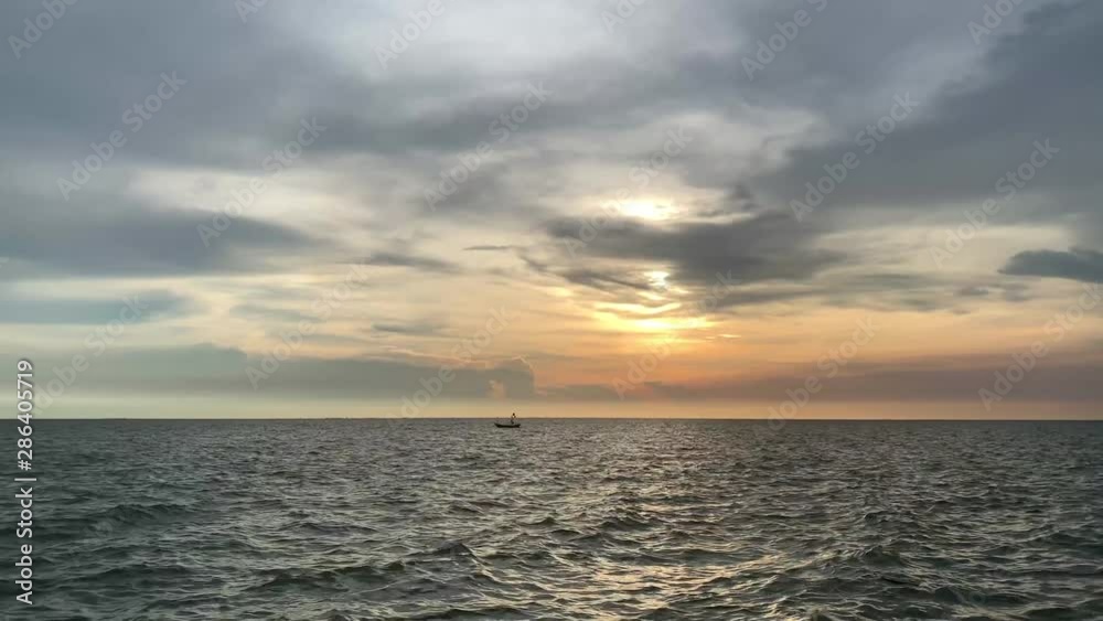 A fishing boat floating on the beautiful sea in the evening A fishing boat floating on the beautiful sea in the evening