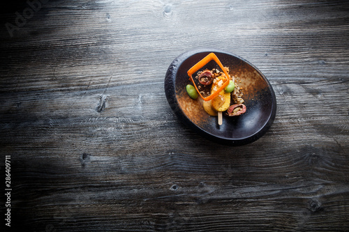 Fototapeta Naklejka Na Ścianę i Meble -  top view on exclusive fish dish with beautiful garnish