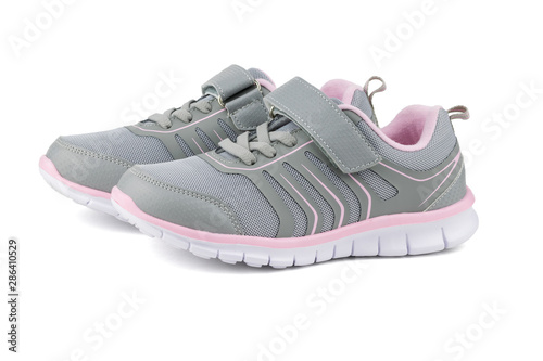 Gray with pink children's sneakers isolated on white background.