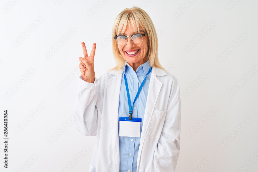 Middle age scientist woman wearing glasses and id card over isolated white background smiling with happy face winking at the camera doing victory sign. Number two. Middle age scientist woman wearing glasses and id card over isolated white background smiling with happy face winking at the camera doing victory sign. Number two.