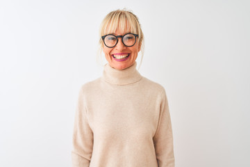 Middle age woman wearing turtleneck sweater and glasses over isolated white background with a happy and cool smile on face. Lucky person.