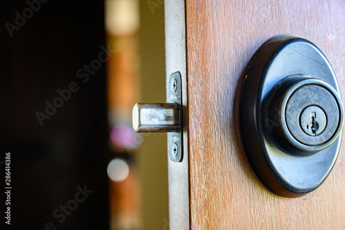 Tablou pe pânză Deadbolt on wooden door engaged with bolt extended