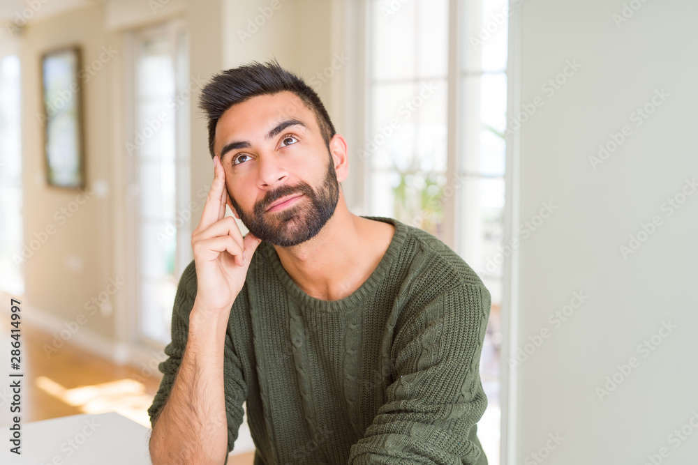 Handsome man thinking confused about doubt, questioning an idea Handsome man thinking confused about doubt, questioning an idea