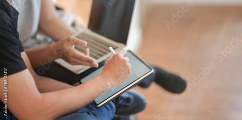 Close-up view of young men discussing the group projects together