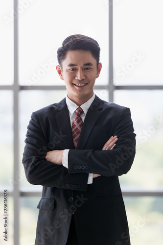 Businessman standing and crossed his arm..