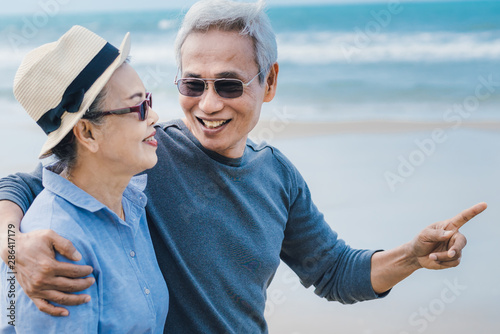 Happy asian couple senior eldery retirement resting at beach honeymoon family together happiness people lifestyle