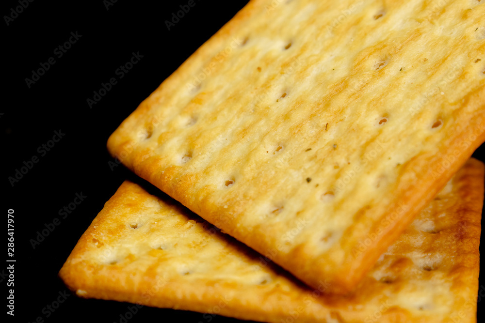 Fototapeta premium Cracker cookies on dark background.