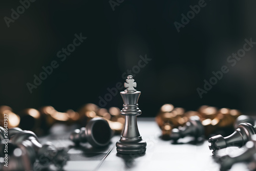 Gold Chess game king winner staying victory on chessboard Business planing strong concept with black background