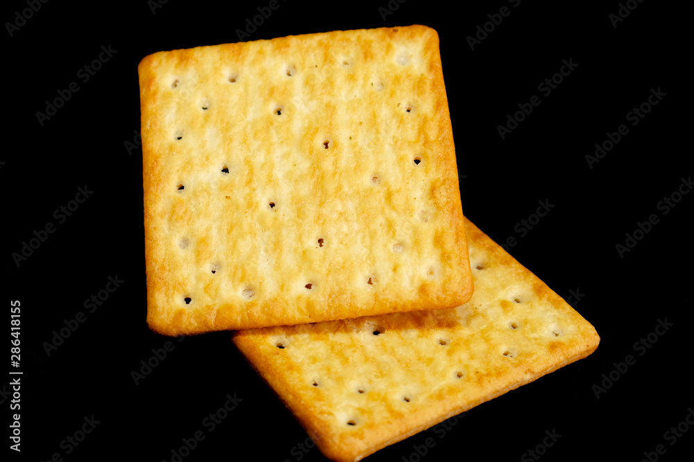 Cracker cookies on dark background.