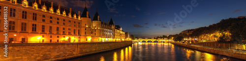 Panorama of Illuminated Conciergerie and Pont Neuf bridge at night - Paris, France. © UlyssePixel