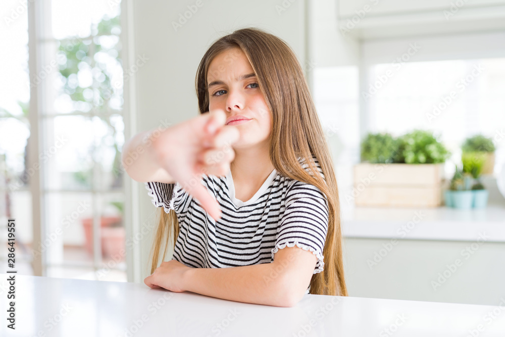 Beautiful young girl kid wearing stripes t-shirt looking unhappy and angry showing rejection and negative with thumbs down gesture. Bad expression. Beautiful young girl kid wearing stripes t-shirt looking unhappy and angry showing rejection and negative with thumbs down gesture. Bad expression.