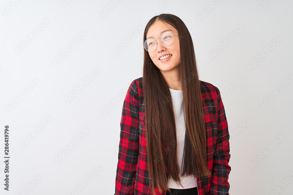 Young chinese woman wearing casual jacket and glasses over isolated white background looking away to side with smile on face, natural expression. Laughing confident. Young chinese woman wearing casual jacket and glasses over isolated white background looking away to side with smile on face, natural expression. Laughing confident.