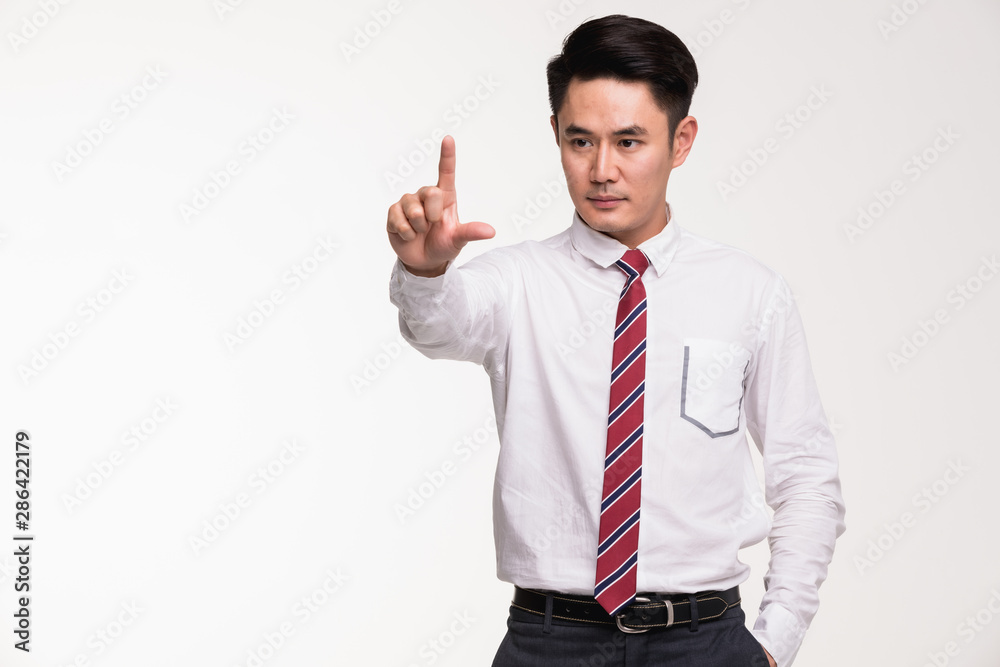 Asian businessman standing and point his finger.. Asian businessman standing and point his finger..