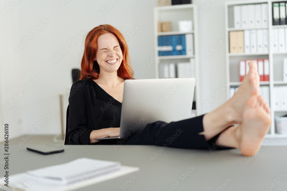 Carefree barefoot businesswoman laughing Carefree barefoot businesswoman laughing