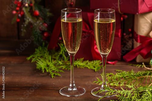 Christmas holiday table with glasses and a bottle of wine of champagne