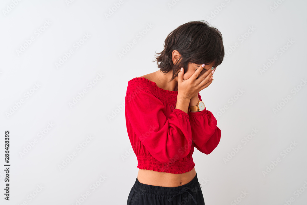 Young beautiful woman wearing red summer t-shirt standing over isolated white background with sad expression covering face with hands while crying. Depression concept. Young beautiful woman wearing red summer t-shirt standing over isolated white background with sad expression covering face with hands while crying. Depression concept.