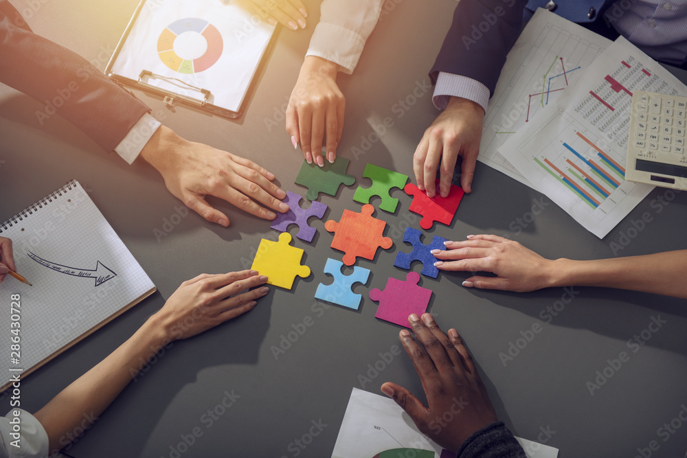 Teamwork of partners. Concept of integration and startup with puzzle pieces Teamwork of partners. Concept of integration and startup with puzzle pieces