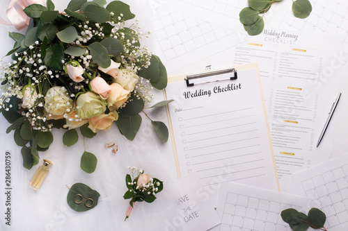 Empty checklist with planner and bouquet of roses