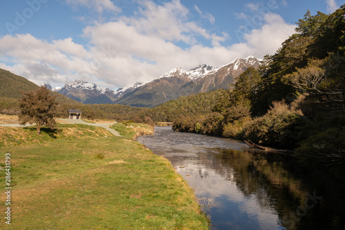 Beautiful calm river winding its way through the Southern Alps in Fiordland New Zealand
