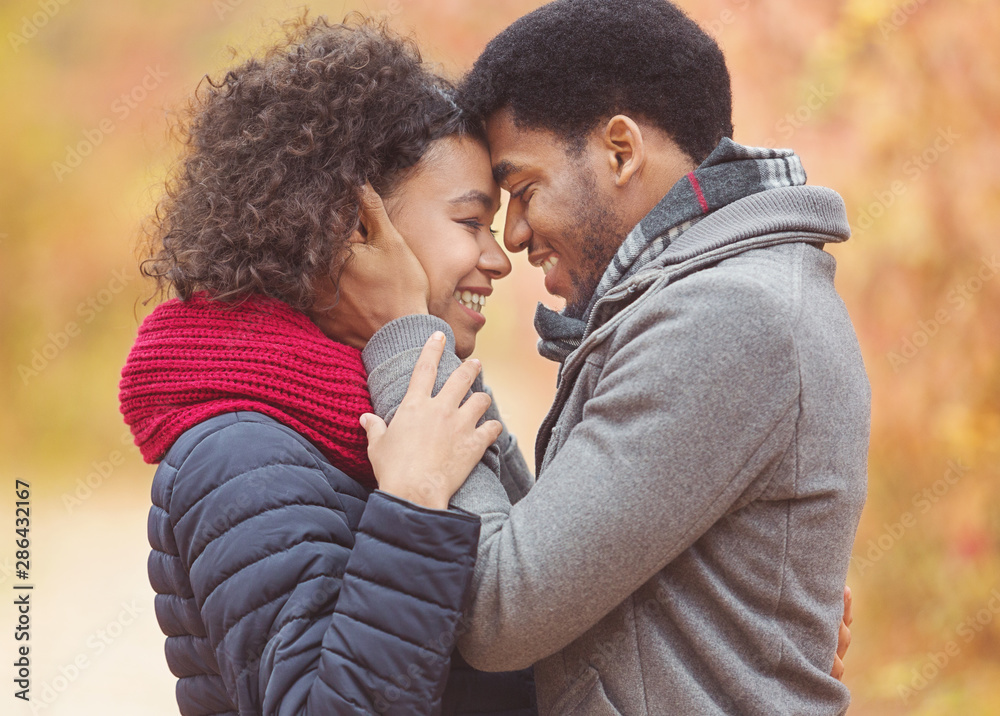 Tender afro couple bonding to each other, touching foreheads Tender afro couple bonding to each other, touching foreheads