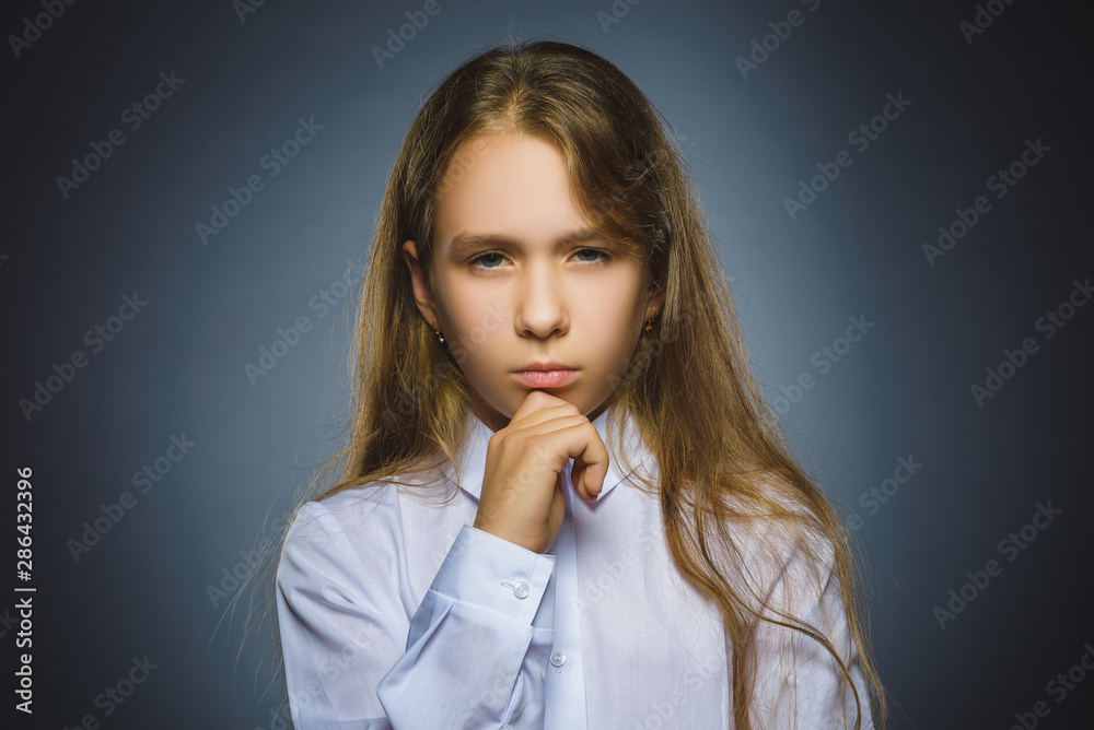 Closeup Thoughtful girl with Hand at head isolated on Gray Closeup Thoughtful girl with Hand at head isolated on Gray