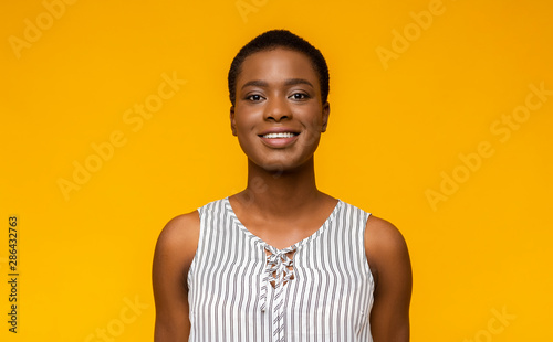 Young pretty black girl smiling at camera © Prostock-studio